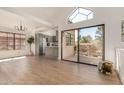 Bright living room with wood floors, a large window, and a sliding door to a patio at 1001 N Pasadena -- # 5, Mesa, AZ 85201