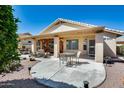 Enjoy outdoor living on this covered patio, complete with a seating area and scenic backyard views at 17741 N Desert Flower Trl, Surprise, AZ 85374