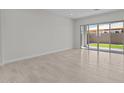 Bright living area with neutral tile flooring and sliding glass doors that provide access to the backyard at 19323 W San Juan Ave, Litchfield Park, AZ 85340