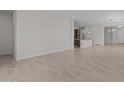 Open-concept living space with neutral tile floors provides seamless flow to the kitchen area at 19323 W San Juan Ave, Litchfield Park, AZ 85340
