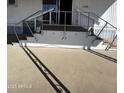 Exterior view of the staircase leading to the entrance of the home, with railing and house number at 25 S 102Nd St # 79, Mesa, AZ 85208