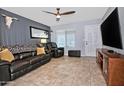 Living room with tile floors, ceiling fan, sleek furnishings and neutral paint at 3661 W Oakland St, Chandler, AZ 85226