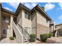 Apartment building exterior with stone accents, stairs, and neat landscaping at 7009 E Acoma, Lot 2134 Dr # 2134, Scottsdale, AZ 85254