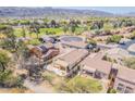 Desert community home with well-kept lawn, patio, fire pit, and golf course in the background at 7227 S Golfside Ln, Phoenix, AZ 85042