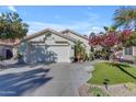 Charming home with a manicured front yard, lush landscaping, and a two-car garage at 842 W Saragosa St, Chandler, AZ 85225