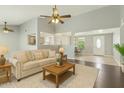 Comfortable living room with neutral colors, ceiling fan, and open floor plan to other rooms at 9716 N 55Th Ave, Glendale, AZ 85302