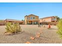 Wide shot of a spacious backyard featuring desert landscaping and a tile walkway at 1309 E Daisy Way, San Tan Valley, AZ 85143