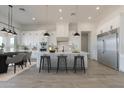 Bright open concept kitchen with white cabinets, large island, and stainless steel appliances at 13952 E Barwick Dr, Scottsdale, AZ 85262