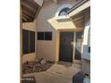 Front entryway with textured stucco, black security door and tiled foyer at 18002 N 12Th St # 19, Phoenix, AZ 85022