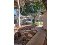 Beautiful front yard with desert landscaping, red rock, trees and stone pavers at 18002 N 12Th St # 19, Phoenix, AZ 85022