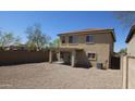 View of a two-story home featuring a covered patio and fully enclosed gravel backyard at 181 S 227Th Ln, Buckeye, AZ 85326