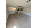 Spacious bonus room with neutral carpet, a ceiling fan, and a view of the staircase at 181 S 227Th Ln, Buckeye, AZ 85326