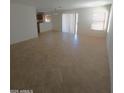 Bright living room with tile flooring and natural light from sliding glass doors and windows at 181 S 227Th Ln, Buckeye, AZ 85326