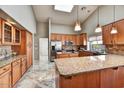 Spacious kitchen featuring a skylight, granite countertops, stainless steel appliances, and ample storage at 19021 N 90Th Ln, Peoria, AZ 85382