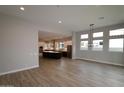 Open-concept living room flows into modern kitchen; lots of natural light from large windows at 1956 W Rowel Rd, Phoenix, AZ 85085