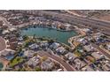 Beautiful aerial view overlooking well-maintained houses in a lakeside community near a busy highway at 19934 N 77Th Ave, Glendale, AZ 85308