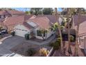 Attractive front exterior view of a single-story home featuring desert landscaping and mature palm trees at 19934 N 77Th Ave, Glendale, AZ 85308