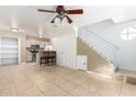 Open-concept living room connected to the kitchen featuring a breakfast bar and tile flooring at 2301 E University Dr # 505, Mesa, AZ 85213