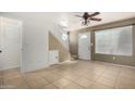 Inviting living room with tile flooring, ceiling fan, and a unique staircase at 2301 E University Dr # 505, Mesa, AZ 85213