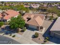 Aerial view of a single-story home with mature trees, tile roof, and two-car garage at 2381 E Firerock Dr, Casa Grande, AZ 85194