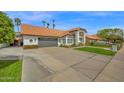 Image of a well maintained home with a desert landscape and gray garage door at 2924 E Mallory St, Mesa, AZ 85213