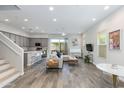Open-concept living room features wood floors, neutral walls, and ample natural light from a sliding glass door at 3045 N 37Th Way, Phoenix, AZ 85018