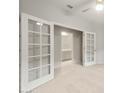 Bright office space with white French doors leading to en suite bathroom and neutral color palette at 6247 W Georgetown Way, Florence, AZ 85132