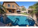 Relax in this backyard oasis featuring a refreshing pool, outdoor seating, and manicured landscaping at 10037 W Chipman Rd, Tolleson, AZ 85353