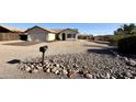 Charming single-story home with low maintenance desert landscaping, and a two-car garage at 10241 E La Palma Ave, Gold Canyon, AZ 85118