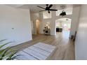 Bright open-concept living space with modern flooring, arched doorways, and a view into the kitchen at 10241 E La Palma Ave, Gold Canyon, AZ 85118