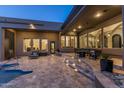 Beautiful backyard showcasing a stone patio, pool, steps with lighting and various seating options with modern design at 11320 N Crestview Dr, Fountain Hills, AZ 85268