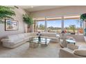 Spacious living room boasts bright windows, neutral tones and scenic outdoor views at 11922 N 120Th St, Scottsdale, AZ 85259