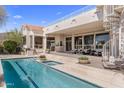 Relaxing pool and spa with a spiral staircase leading to upper deck offer an outdoor oasis at 11922 N 120Th St, Scottsdale, AZ 85259