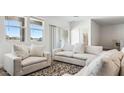 Comfortable living room features lots of seating with three windows bringing in natural light at 12443 E Bahia Ct, Florence, AZ 85132