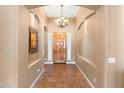Inviting foyer with wood door, arched entryway and tiled floor at 12493 S 179Th Ln, Goodyear, AZ 85338