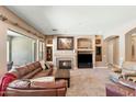 Cozy living room with fireplace, comfortable seating, and plenty of natural light at 12493 S 179Th Ln, Goodyear, AZ 85338