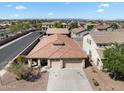 Aerial view of a home showcasing its three-car garage, desert landscaping and neighborhood at 14694 W Mandalay Ln, Surprise, AZ 85379