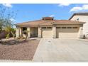 Inviting single-story home featuring a three-car garage and well-maintained landscaping at 14694 W Mandalay Ln, Surprise, AZ 85379