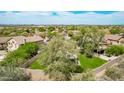 An aerial view of a neighborhood showing homes with tile roofs and desert landscaping at 15691 N 104Th Pl, Scottsdale, AZ 85255