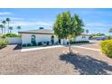 Inviting home exterior with well-manicured landscaping and shaded seating area at 1607 E Gable Ave, Mesa, AZ 85204