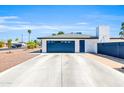 Large garage featuring a wide driveway and side access, perfect for extra parking at 1607 E Gable Ave, Mesa, AZ 85204
