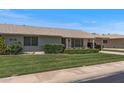 Charming single-story home with well-manicured lawn and covered carport, perfect for easy access at 19046 N Signal Butte Cir, Sun City, AZ 85373