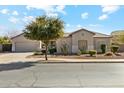 Charming single-story home with desert landscaping and a spacious two-car garage on a sunny day at 19305 E Oriole Way, Queen Creek, AZ 85142