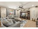 Inviting living room with a cozy sectional sofa, custom built-in entertainment center, and neutral decor at 19305 E Oriole Way, Queen Creek, AZ 85142