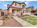 Two-story home boasts a covered porch with seating, surrounded by manicured landscaping and a cozy neighborhood at 2307 E Pecan Rd, Phoenix, AZ 85040