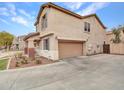 Spacious home with a two-car garage, complemented by a well-maintained yard and inviting front porch at 2307 E Pecan Rd, Phoenix, AZ 85040