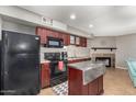 Well-designed kitchen with stainless steel island and fireplace in attached room at 2315 W Union Hills Dr # 124, Phoenix, AZ 85027