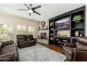 Cozy living room features a fireplace, built-in entertainment center, and comfortable leather seating at 33550 N Dove Lakes Dr # 1041, Cave Creek, AZ 85331