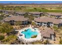 Aerial view of resort-style community pool and lounge area surrounded by lush landscaping and desert views at 33550 N Dove Lakes Dr # 1041, Cave Creek, AZ 85331
