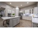 Well-equipped kitchen with an island, stainless steel appliances, and white cabinetry at 33601 N 64Th St, Scottsdale, AZ 85266